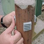A Person Engaged in Attaching a Post to a Pole
